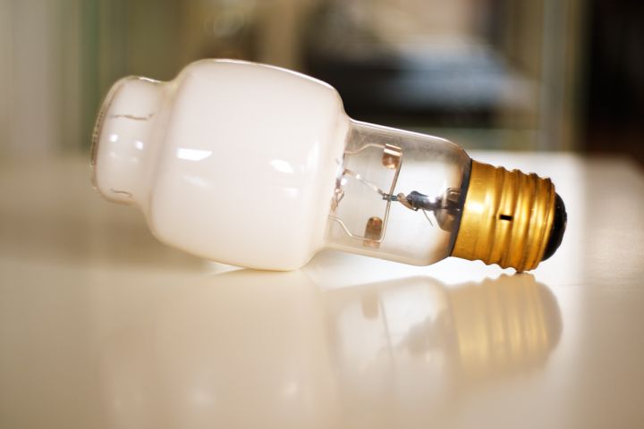 RLOD#34 (2020.06.18) 1979 Sylvania H38JA-100/N

Although Sylvania introduced its first warm-white high-pressure mercury lamps in 1973, it did not release a 100 W variant before 1977. Further technology developments were required in order to make a smaller lamp with suitable characteristics. First, the phosphor coating was improved into a more scratch resistant one which enabled a fully coated bulb. This eliminated the leakage of uncorrected bluish mercury light from the bulb crown, a part that was usually left uncoated. Second, the nature of the fluorescent material was also changed to a mix of magnesium fluorogermanate and 2nd-gen yttrium vanadate, a formulation similar to that elaborated by Westinghouse five years earlier (minus the fine silica coating). This phosphor blend, applied in a thick layer, radiates in the red end of the spectrum and absorbs part of mercury's blue light, which shifts the light color temperature to 3000 K, about 1000 K lower than that of regular fluorescent mercury lamps. The warm-white light produced this way was compatible with that of incandescent lamps and fluorescent tubes, thus facilitating its adoption in indoors and commercial/retail lighting applications.

The resulting H38JA-100/N, shown here, proved superior to the company's older warm-white mercury lamps (/N and /WDX). Its bulb color has a much whiter tint than that of 1st-gen Warmtone /N lamps, it delivers a more pleasing light color, and has more stable photometric and colorimetric properties. However, like in Westinghouse's Styletone lamps, the use of a very thick phosphor coat results in significant optical losses that limits the initial lumen output to 3750 lm only, 16.7 % less than that of the standard (4000 K) bright white deluxe variant. This limitation pushed Sylvania to upgrade its Warmtone mercury lamps further, resulting in the introduction in 1980 of brighter lamps (+33 % at 100 W) coated with a blend of yttrium vanadate and yttrium aluminum garnet phosphors. However, this came at the cost of a higher light color temperature and a degraded color quality which made those lamps no longer suitable for a use in combination with incandescent lamps.


Keywords: Lamps