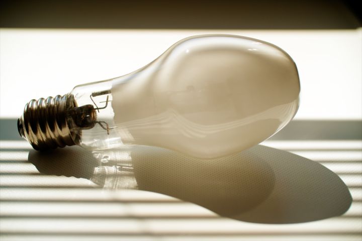 RLOD#11 (2020.05.15) 2010 GE MVR250/C/U

The MVR250/C/U shown here is representative of the last generation of fluorescent metal halide discharge lamp produced by General Electric in the USA. Typical of standard American metal halide lamps intended for general lighting applications, this model has a sodium-scandium iodide fill chemistry that delivers a high initial light output with a reasonably good light color quality. Its fluorescent coating, consisting of a standard red-emitting europium-activated yttrium vanadate material, reduces glare, lowers the light color temperature by 300 K to 3900 K, and raises the light color rendering by 5 points to 70 Ra8, thus making it an ideal source of intensive indoors lighting. Interestingly, this MVR250/C/U features a unique bulb shape with a conical neck section, which was most likely introduced in order to facilitate the automated production of the lamp at high speed. This shape enables a better, more consistent seating of the bulb on the rotating heads of sealing machines, thus resulting in a more precise alignment during assembly.


Keywords: Lamps